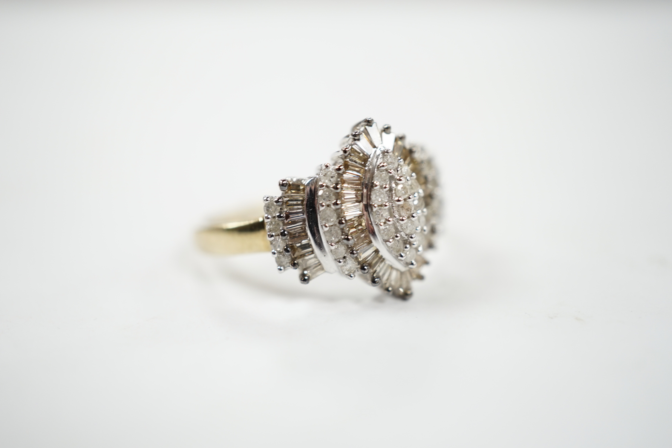 A modern 9ct gold and diamond navette shaped cluster dress ring, set with baguette and round cut stones and diamond cluster set shoulders, size O/P, gross weight 3.2 grams.
